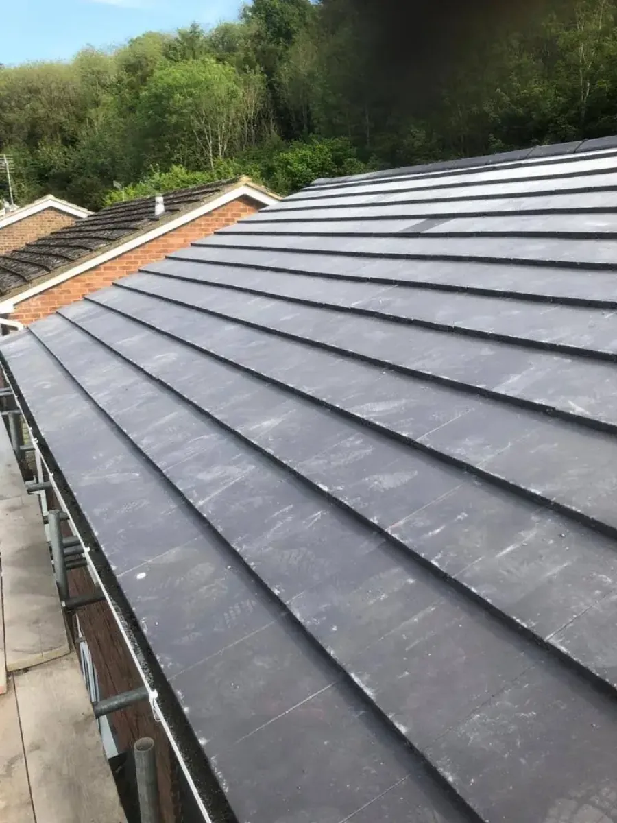 Flat roof membrane being dressed into an upstand in Bagshot