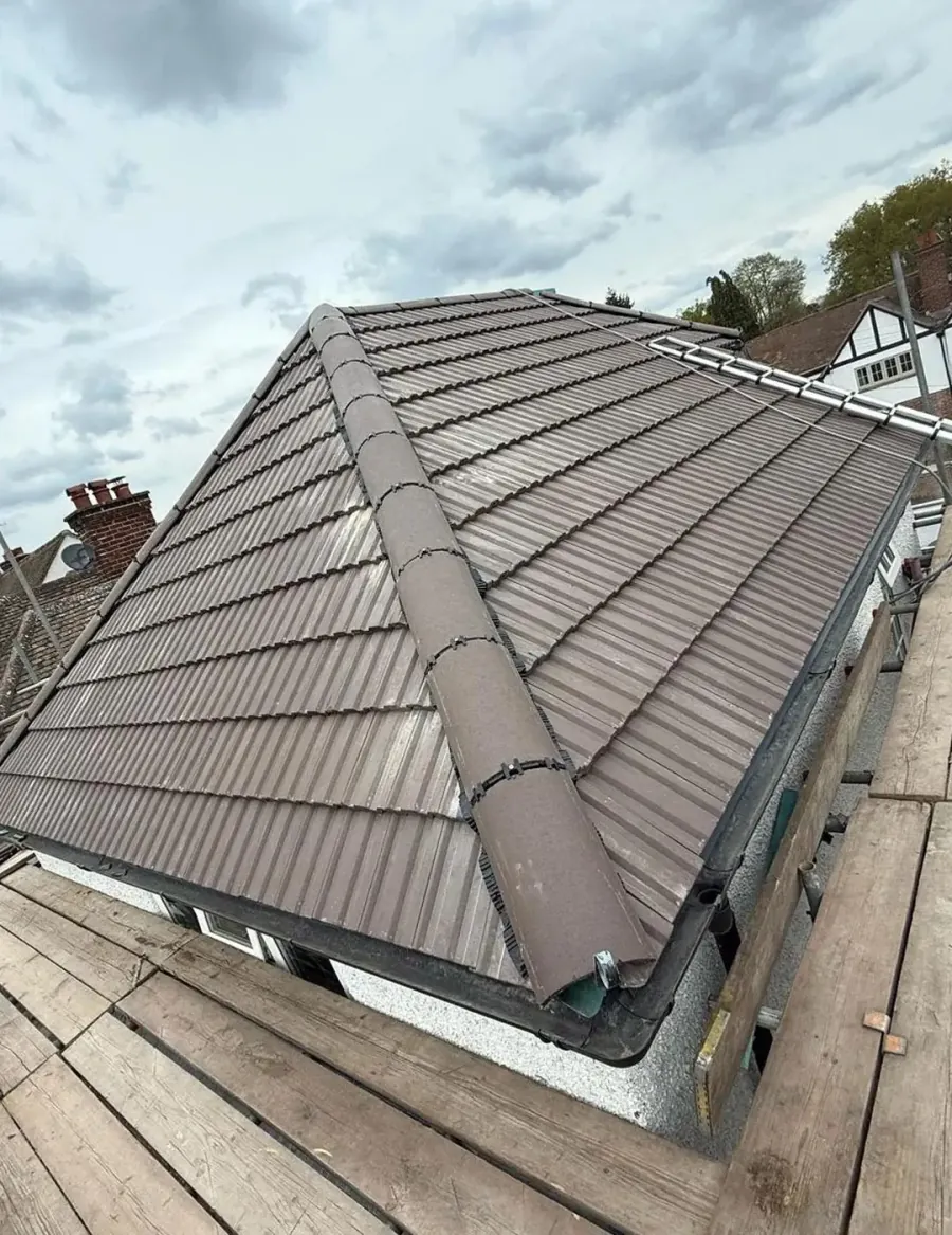 Local roofer fitting tiles during a re-roof near Bagshot