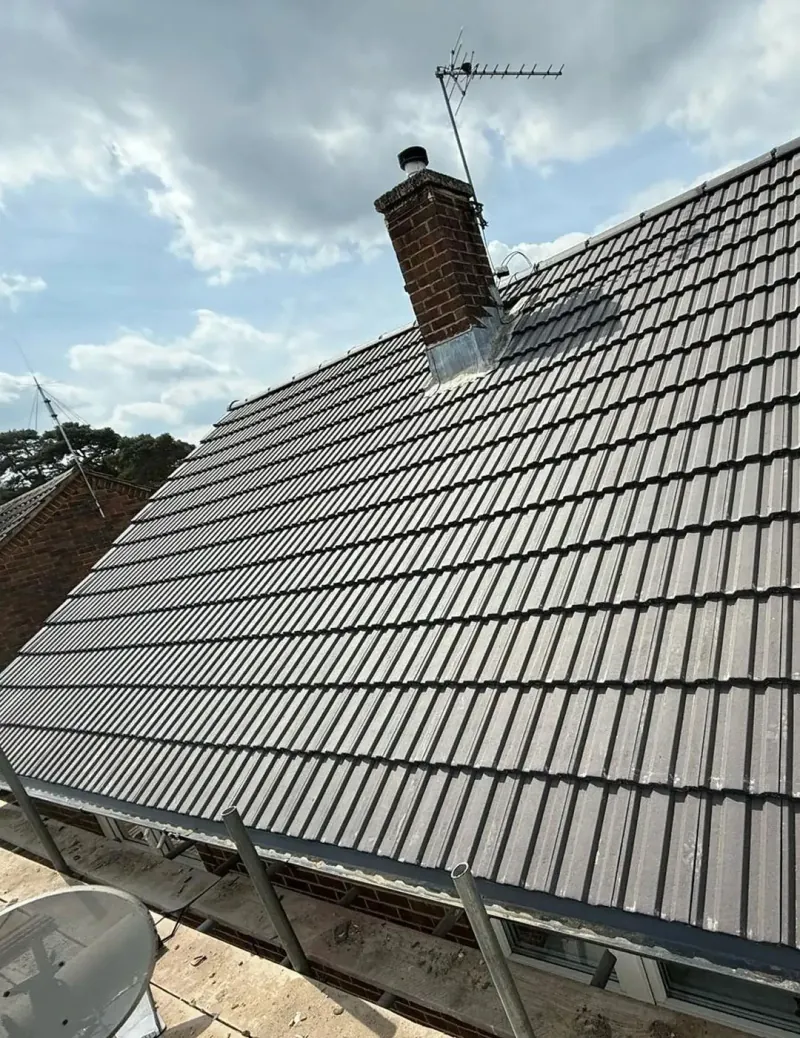 Pitched roof being re-tiled with scaffolding in place